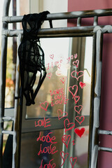 sexy girl writes a love message on the mirror and glass with red lipstick. The phrase I love you on the first date of a man and a woman. Erotic and romantic atmosphere with hearts and black lace bra