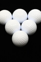 Golf balls on a black background 