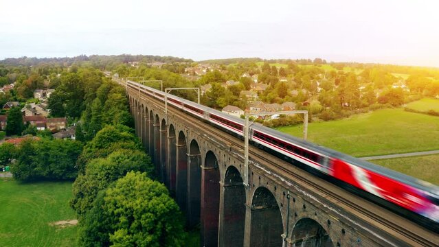 Aerial of a train riving over The Ouse Valley Viaduct across the river Ouse in Sussex England. 