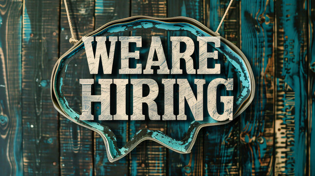 Weathered blue wood wall with a rustic we are hiring sign, inviting applicants - Powered by Adobe