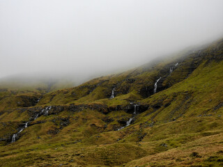 Multiple waterfalls in the hillside in the Faroe Islands