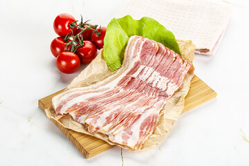 Sliced pork bacon oved board