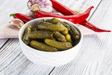 Marinated small cucumbers in the bowl