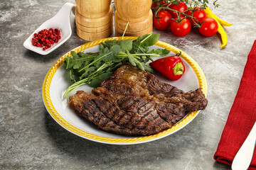 Grilled chuck roll steak with arugula