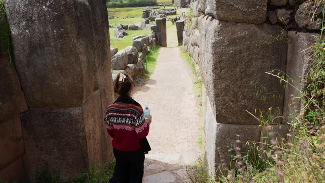 Exploring Inca Ruins. Young Woman Touring Historical Sites in Peru