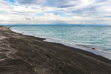 Stunning beach view with black sand at the spit between Lake Pomorie and the Black Sea at Pomorie, Province of Burgas, Bulgaria