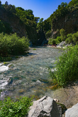 Alcantara Gorge and Alcantara river Park in Sicily, Italy. Water and Volcanic stones wall.