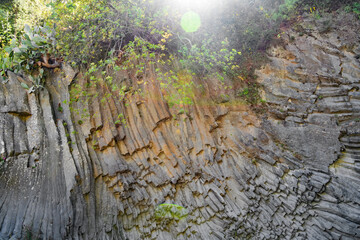 Alcantara Gorge and Alcantara river Park in Sicily, Italy. Water and Volcanic stones wall.