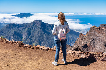 Fototapeta premium Woman with her back turned contemplating the breathtaking views of the Canarian landscape, La Palma.