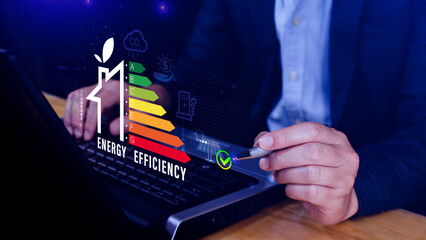 Energy efficiency concept, Businessman touching virtual screen of energy efficiency rating for...
