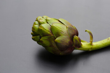 Purple artichoke on dark background.