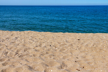 Sand with seashells in front of sea water at Veleka Beach, Sinemorets, Tsarevo Municipality, Province of Burgas, Bulgarian Black Sea