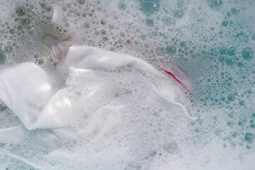 White cloth soaked in powder detergent water dissolution, washing cloth. Laundry concept