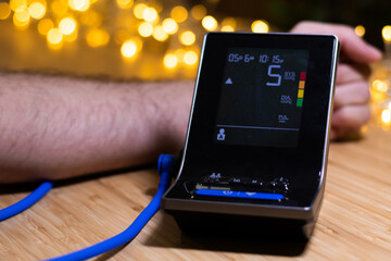 Hypertension Problem. Young man Measuring Arterial Blood Pressure Monitor with a Cuff At Home. Healthcare, Health Issue.