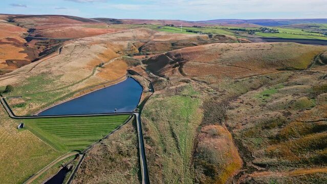 Cinematic, aerial clip of Ogden Reservoir, Oldham, on the edge of the Pennines.