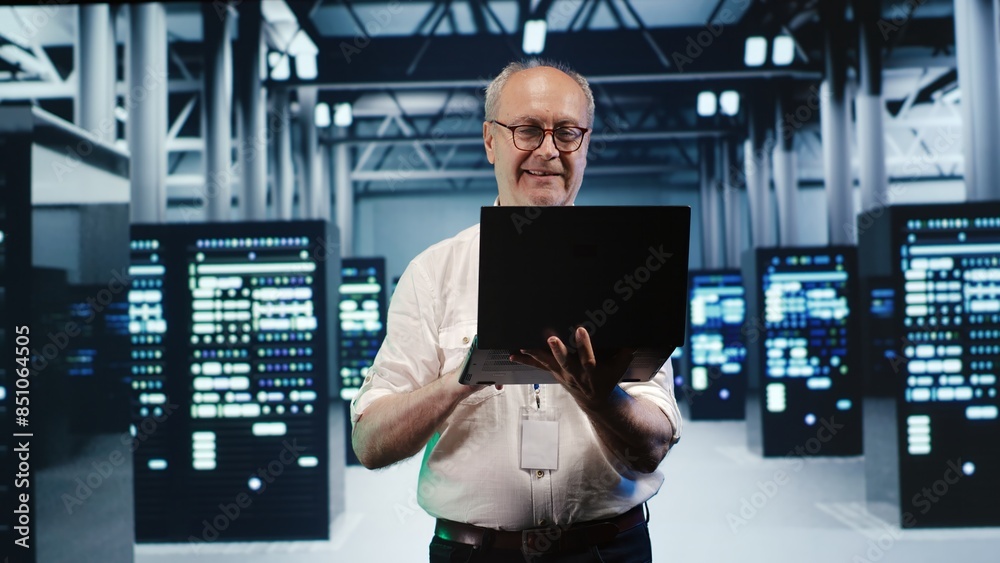 Poster meticulous employee expertly managing data while navigating in industrial server room. precise worke