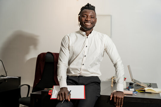 Confident businessman in the office with a smile