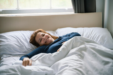 Morning joy of a woman relaxing in bed