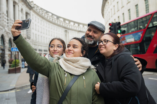 Diverse family taking a selfie in London - Powered by Adobe