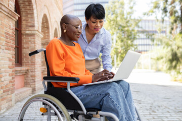Business consultation outdoors for black woman in wheelchair