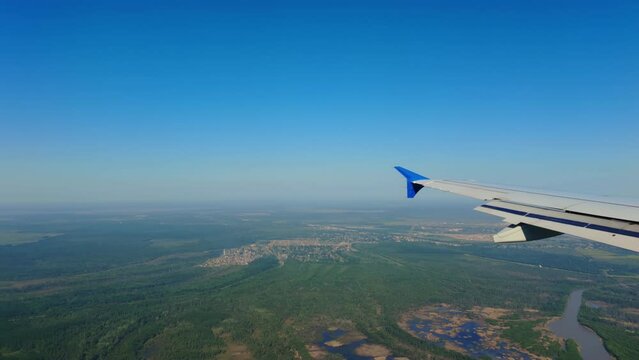 Wide view from porthole of the flying airplane over New Orlean. Wide shot