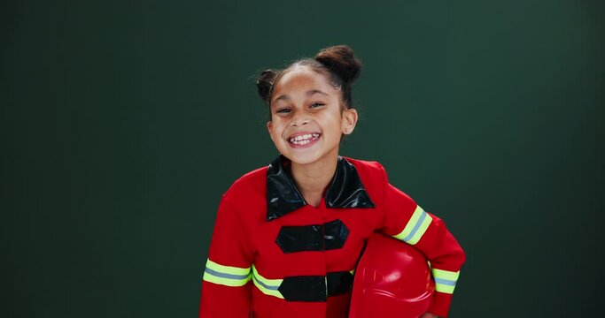 Face, firefighter and girl with smile, helmet and career ambition on dark studio background. Portrait, model or kid with uniform, child development or cheerful with joy, happiness and smile with job