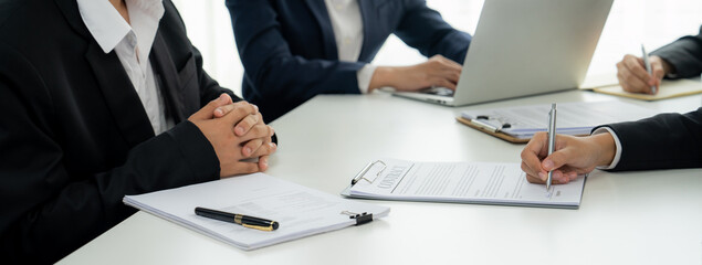 Two business executive in boardroom discuss term and company merging agreement, review corporate...