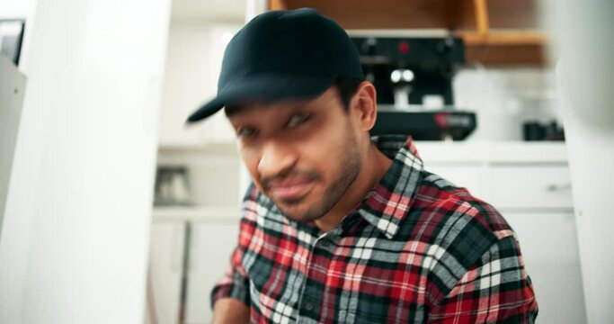 Happy, plumbing and man fix sink in kitchen for repairs, leak and damage to water system. Housework, handyman and plumber with tools for maintenance, drainage installation and inspection for DIY