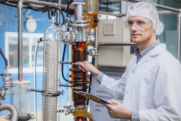Scientist working with Equipment in Science Lab. Medical factory staff Cannabis CBD oil extraction. Hemp oil Thin Film Distillation Plants Process.