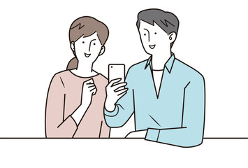 スマホを見ながら会話する若い夫婦