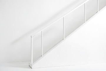 White Staircase Railing Against White Wall