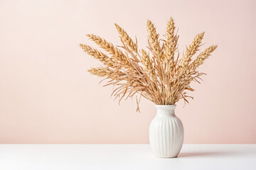 Naklejka premium Dried Wheat in a White Vase on a Pastel Pink Background