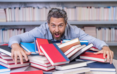 college tutor reading books. back to school. school teacher in library. book lover man gets educated. knowledge day. teacher get knowledge from books. man teacher at bookstore. Deepening knowledge