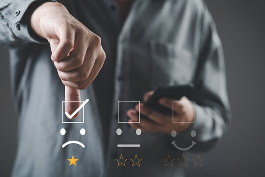 Bad review, bad service dislike bad quality, low rating, social media not good. Customer Experience dissatisfied Concept, Unhappy Businessman Client with Sadness Emotion Face on digital screen.
