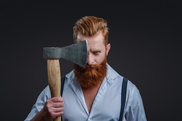 Male brutality. Vintage brutality guy with axe in retro suspenders. Brutal man in suspenders with ax isolated on black. Mature redhead man with hairstyle. Brutal male fashion style. True man