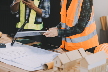 Cropped shot two young architects working together on a building construction site.