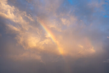 rainbow and clouds on evening sky