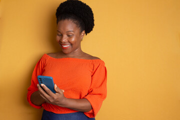 black woman looking at a smartphone