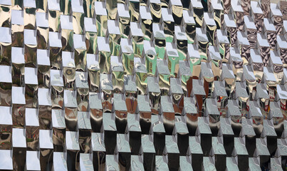 Fototapeta premium Abstract pattern of reflective silver squares. Modern metallic texture, geometric design, and industrial background with a shimmering effect