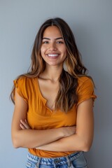 Portrait of a young latin woman with pleasant smile isolated on grey wall