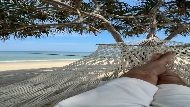Relaxing in a hammock on the beach in Bang Tao, Phuket, Thailand
