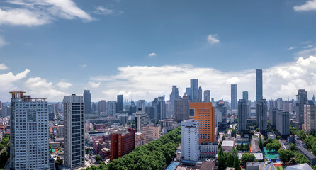 Fototapeta premium Vibrant Urban Skyline Under Blue Skies
