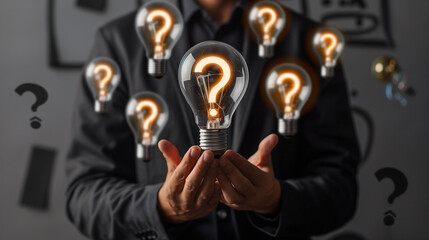 Businessman Holding Lightbulb with Question Mark, Concept of Innovation