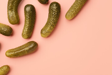 Pickled cucumbers on red background