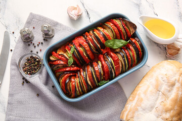 Baking dish of tasty Ratatouille on white marble background