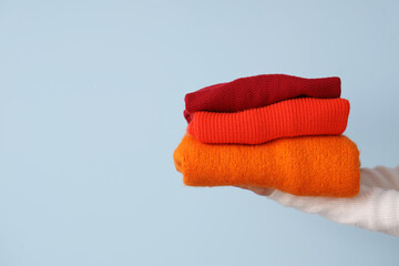 Woman with red sweaters on light background