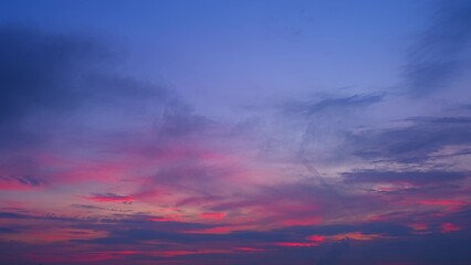 A stunning sunrise with a gradient of colors from deep blue to vibrant pink and purple. The clouds add texture and depth to the sky, creating a serene and breathtaking view. Cloud background.
