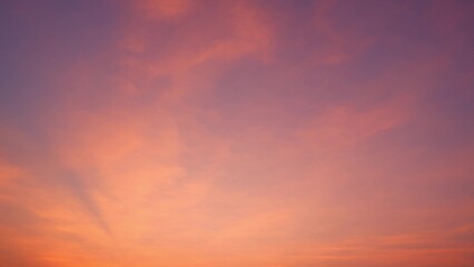 A stunning sunset with a sky painted in hues of pink and purple. The soft clouds blend seamlessly with the vibrant colors, creating a warm and peaceful atmosphere. Sunset sky background.
