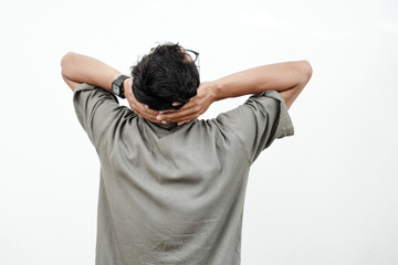 a man facing backwards with his head tilted upwards with his hands behind his head, thinking