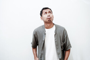 Fototapeta premium an Asian man with an expression of frowning and pursed lips